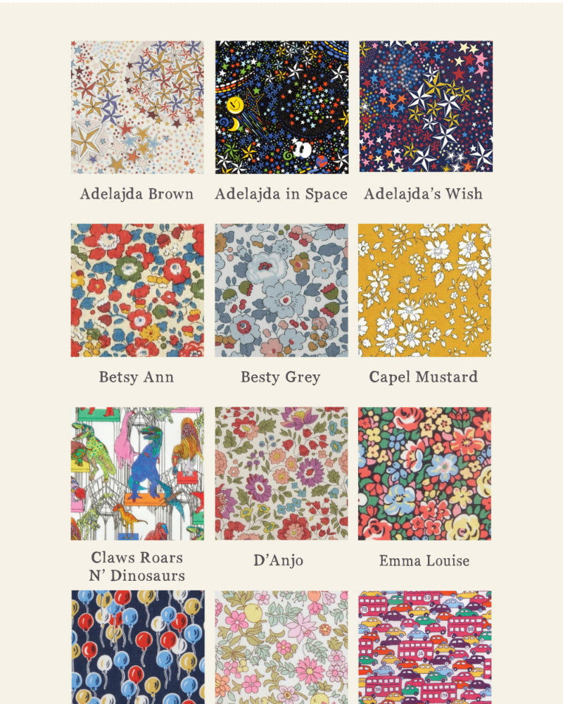 A grid of 24 liberty print fabric swatches with colourful patterns and names underneath, including Adelajda Brown, Besty Ann, Capel Mustard, and others, on a light beige background. The brand name 'Magnificent Stanley' appears at the bottom. Patterns feature cars, planes, flowers, balloons, dinosaurs, stars and cats.