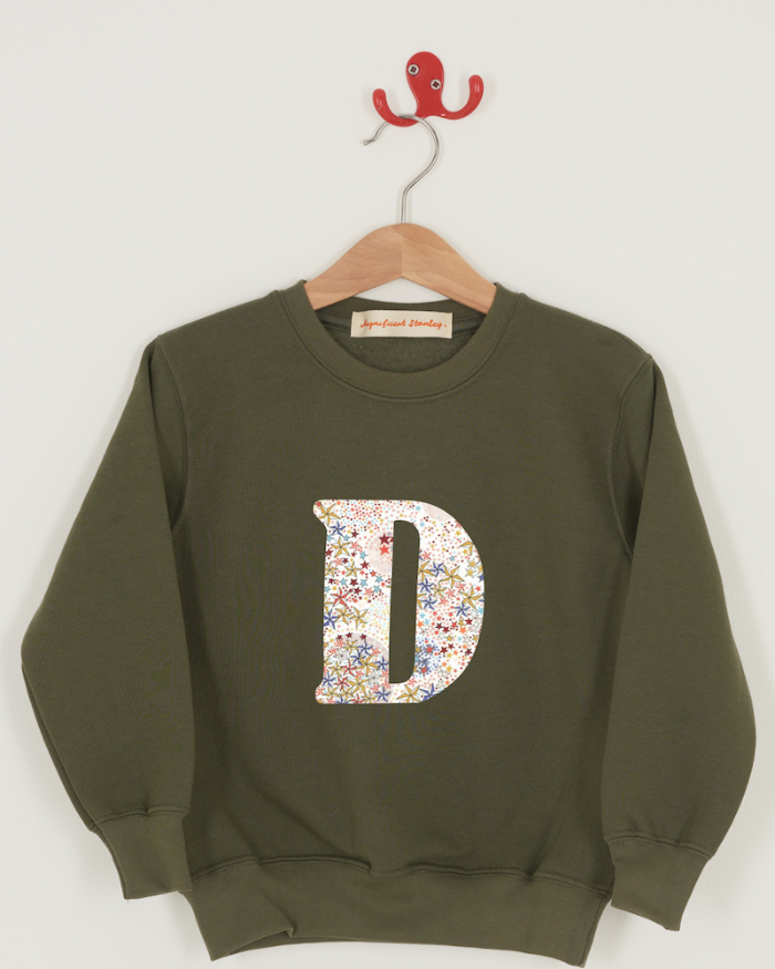 a personalised khaki sweater with a large letter 'D' in Adelajda liberty starry print.