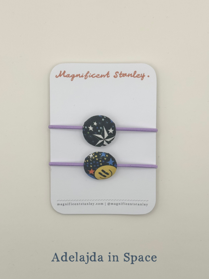 Pair of hair ties with celestial design on a 'Magnificent Stanley' branded card.