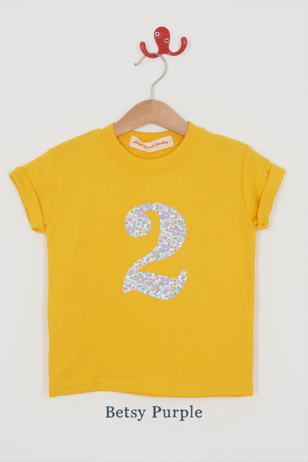 a yellow birthday t-shirt with a number 2 cut from betsy purple liberty floral print on the front.