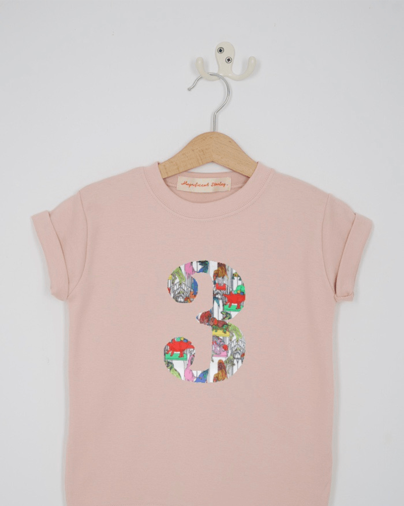 a pink birthday t-shirt with a number 3 cut from dinosaur liberty floral print on the front