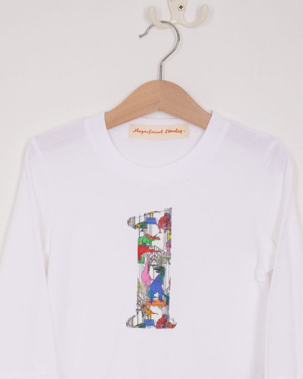 a white birthday t-shirt with a number 1 cut from liberty dinosaur print on the front