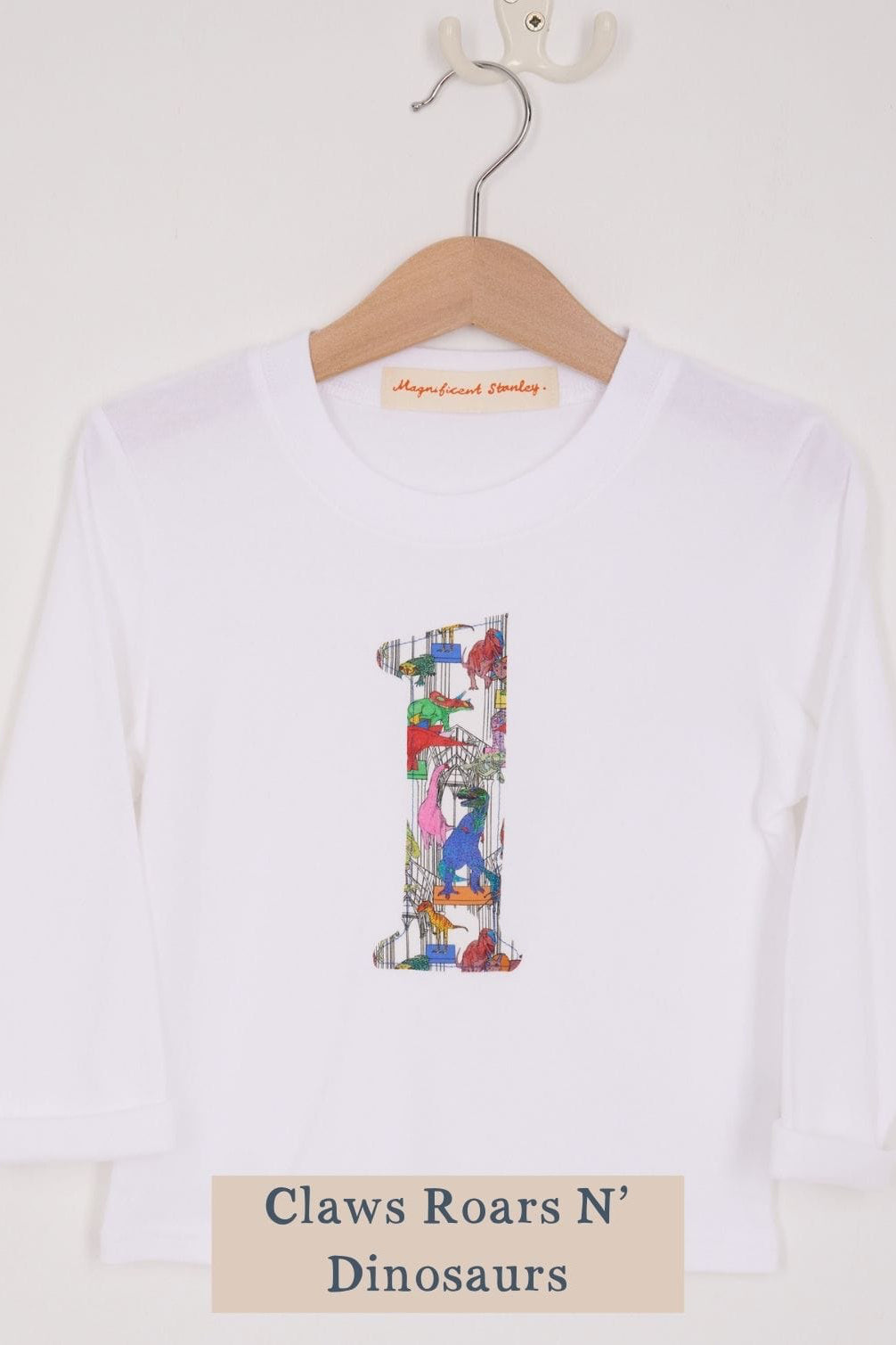 a white birthday t-shirt with a number 1 cut from liberty dinosaur print on the front