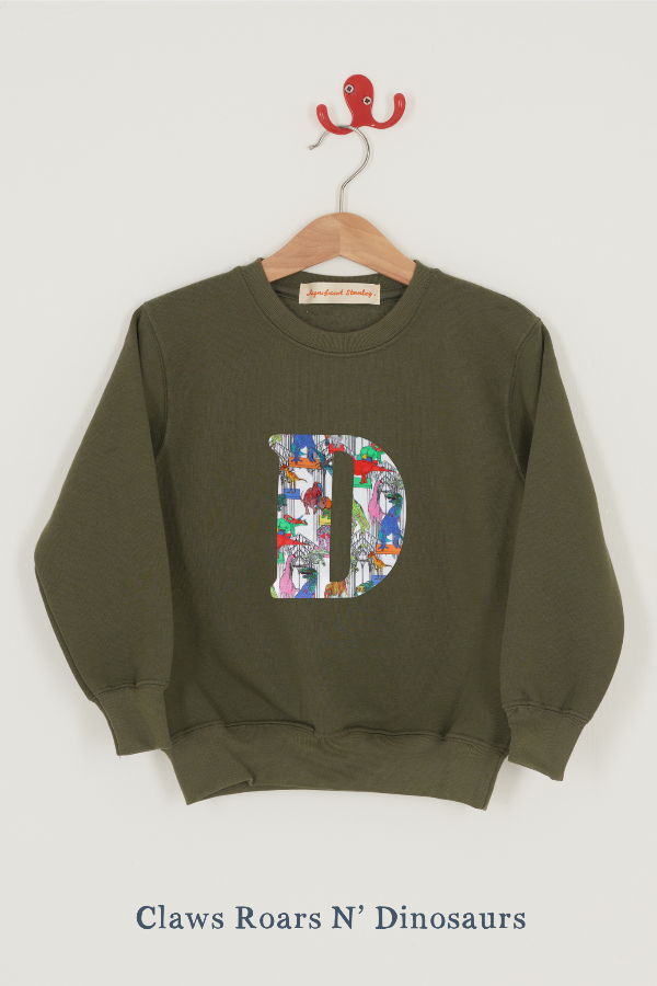 a personalised khaki sweater with a large letter 'D' in claws roars n dinosaurs liberty print.