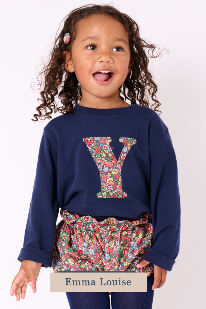 a 3 year old girl wearing a navy cotton t-shirt with the number 2 on the front cut from emma louise liberty print