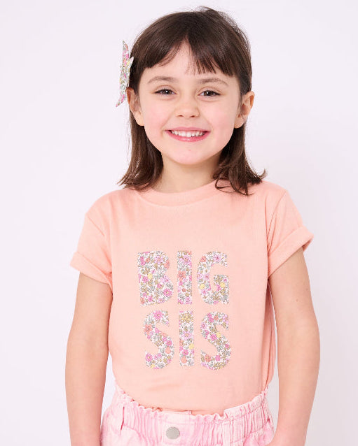A girl wearing a BIG SIS pale Pink T-Shirt in Choice of Liberty Print as a proud big sister