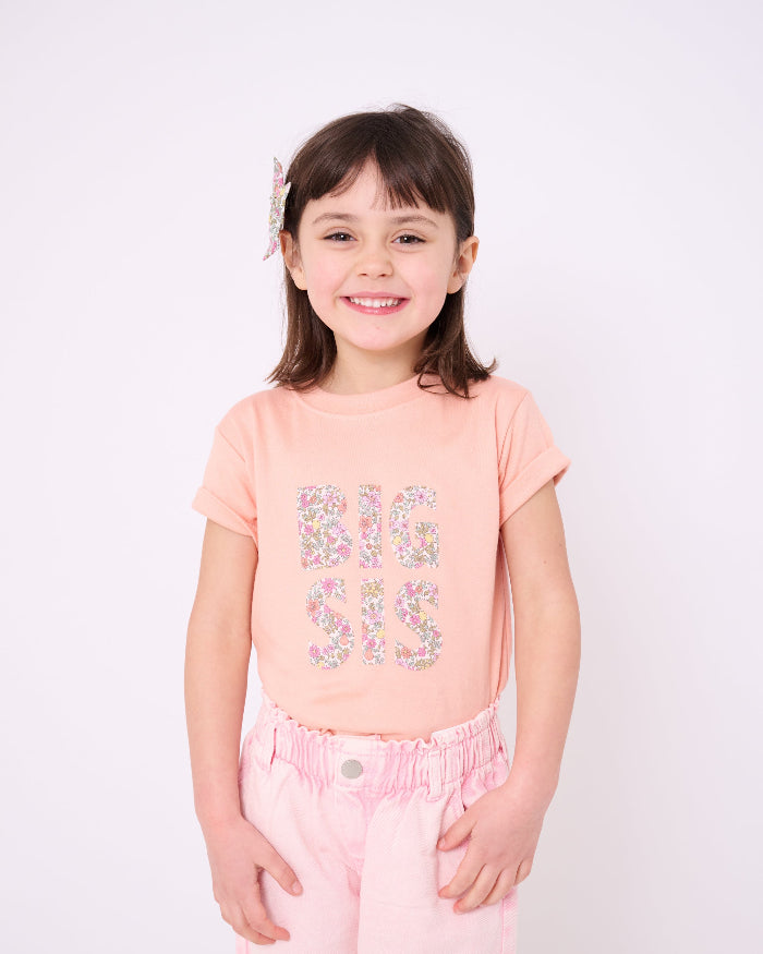A girl wearing a BIG SIS pale Pink T-Shirt in Choice of Liberty Print as a proud big sister