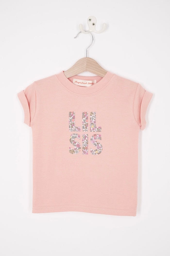 a pink little sister sibling t-shirt with the words Lil Sis on the front cut from floral Liberty print.