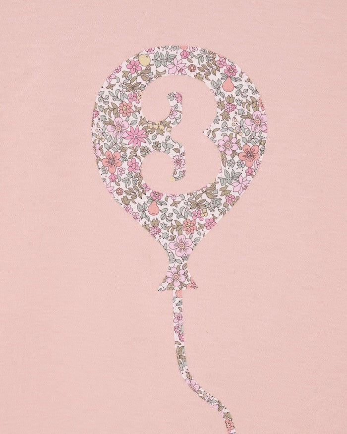 a pink birthday t-shirt with a balloon with the number 3 on it cut from floral Liberty print.