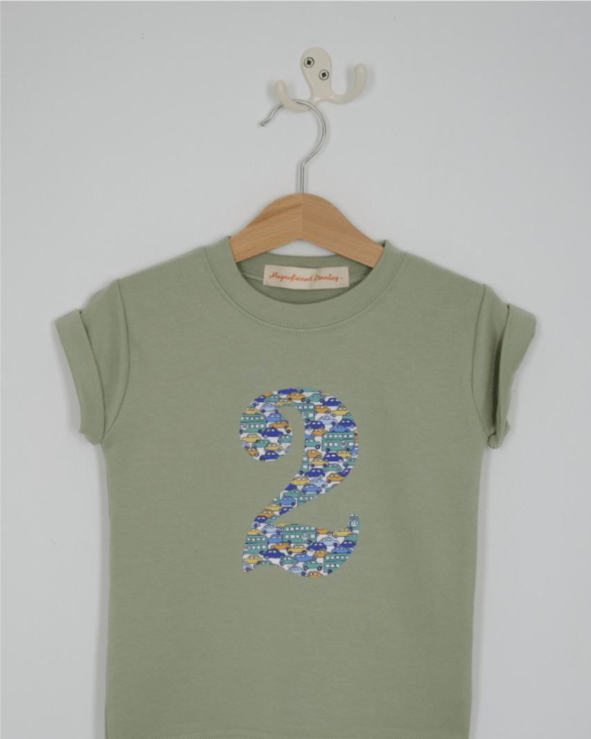 a number 2nd birthday kids sage green t-shirt with a number cut from hop on hop off cars liberty print on the front.