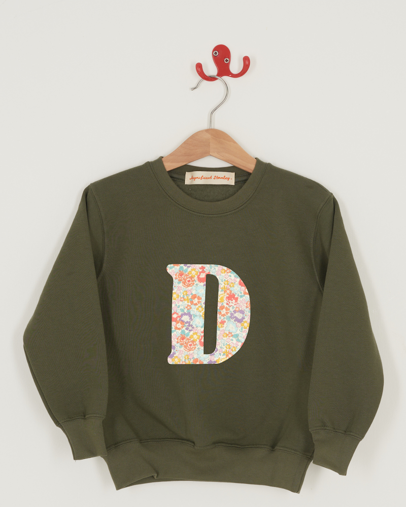 a personalised khaki sweater with a large letter 'D' in michelle liberty print.