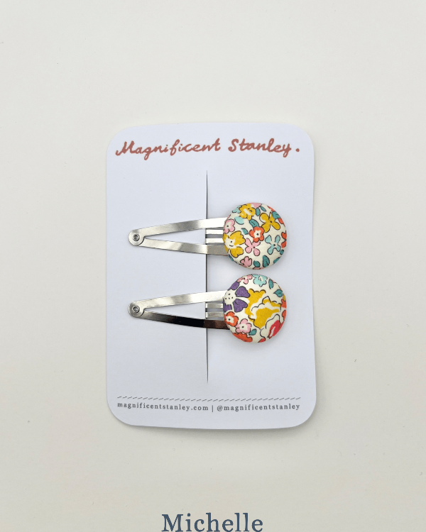 a pair of michelle liberty print bobble hair clips