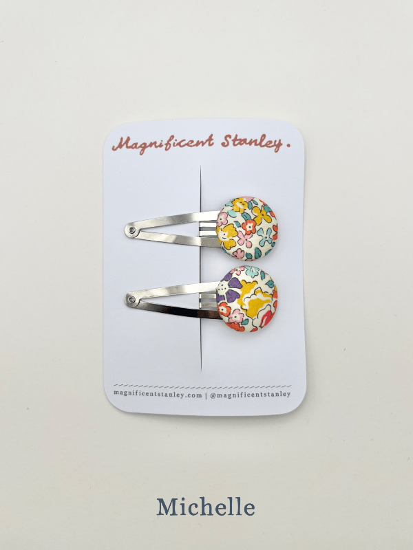 a pair of michelle liberty print bobble hair clips