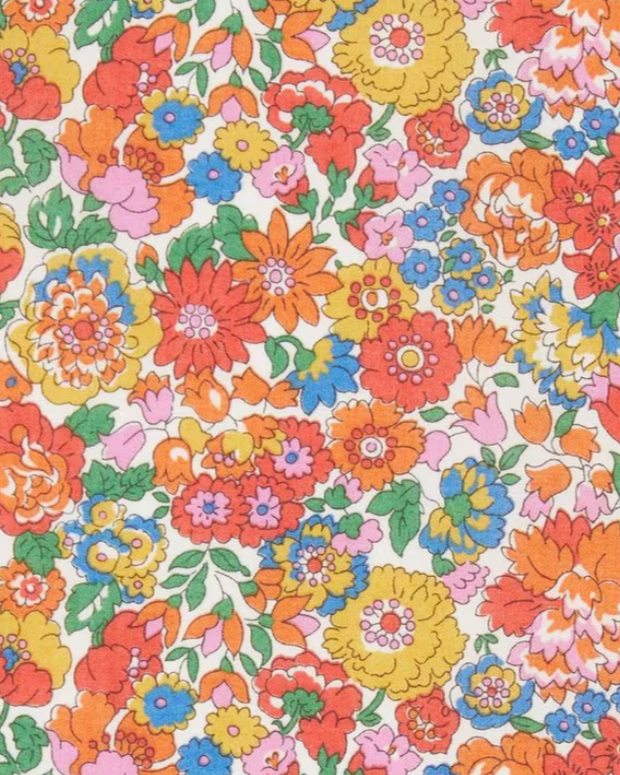A swatch of classic Nell Annie and May Liberty print tana lawn featuring bright spring flowers