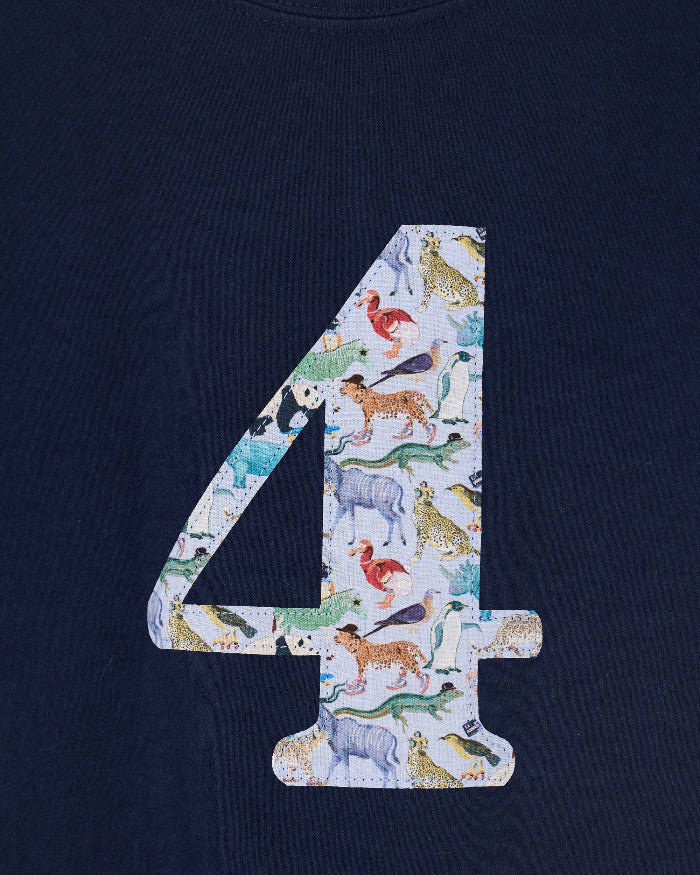 A close up of a navy cotton t-shirt with the number 4 sewn on the front cut from liberty Quey 2 zoo animal print.