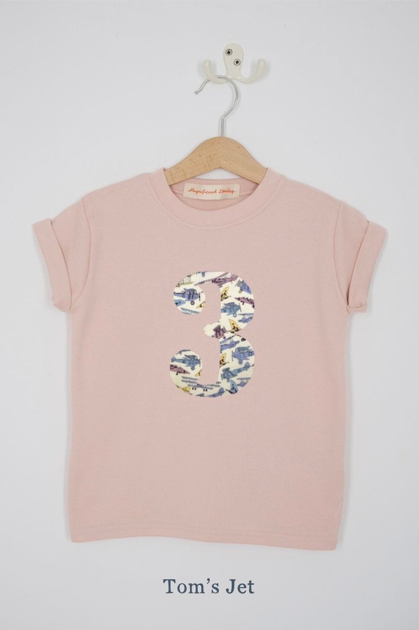 a pink 3rd birthday t-shirt with a number 3 cut from tom's jet liberty vintage planes print on the front