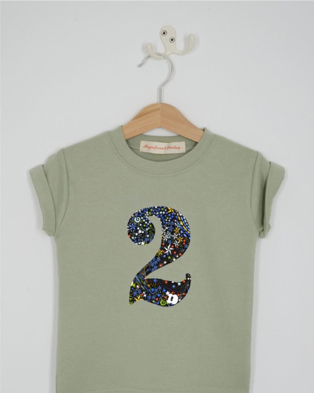 a birthday number 2 kids sage green t-shirt with a number cut from adelaide in space liberty print on the front.