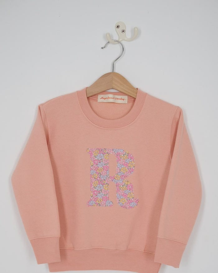 a personalised dusty pink sweatshirt with an initial on in floral Sadie Rose Liberty print on the front.