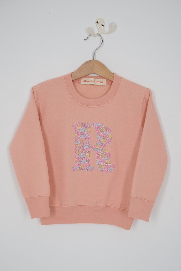 a personalised dusty pink sweatshirt with an initial on in floral Sadie Rose Liberty print on the front.