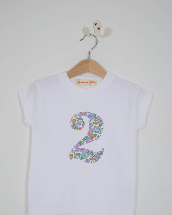 a white birthday t-shirt with a number 2 cut from betsy purple liberty floral print on the front
