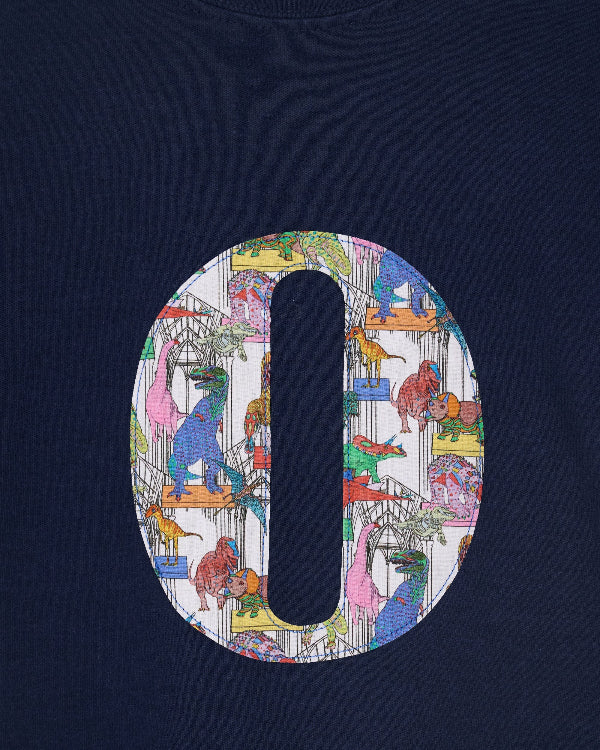 a close up of the stitching on a navy kids personalised t-shirt with a colourful number 4 design in Liberty dinosaur print on the front