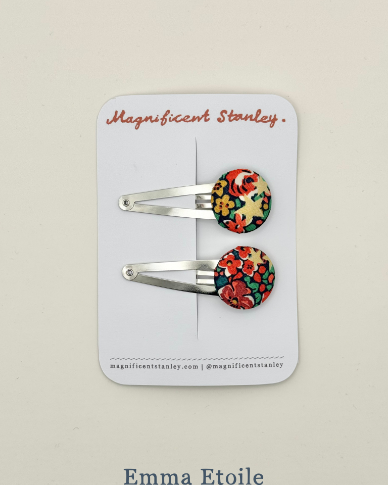 Pair of floral hair clips in Emma Etoile liberty print on a 'Magnificent Stanley' branded card.