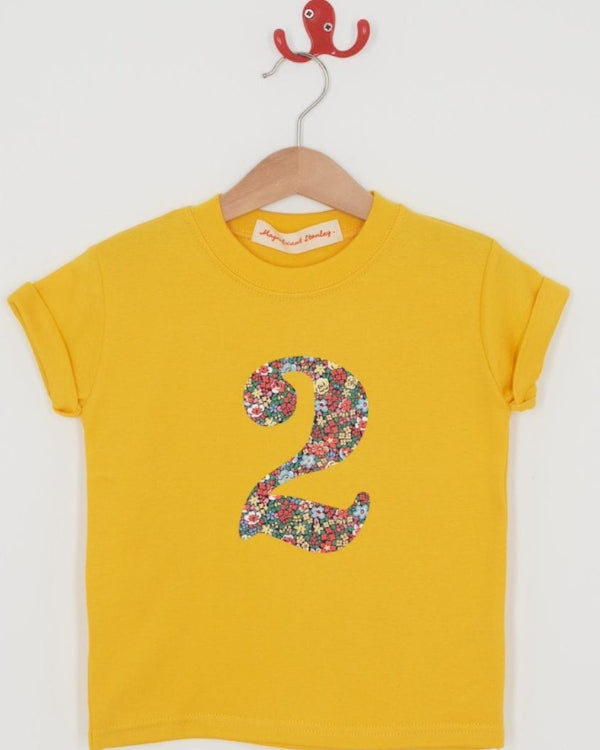 a yellow birthday t-shirt with a number 2 cut from emma louise liberty floral print on the front.