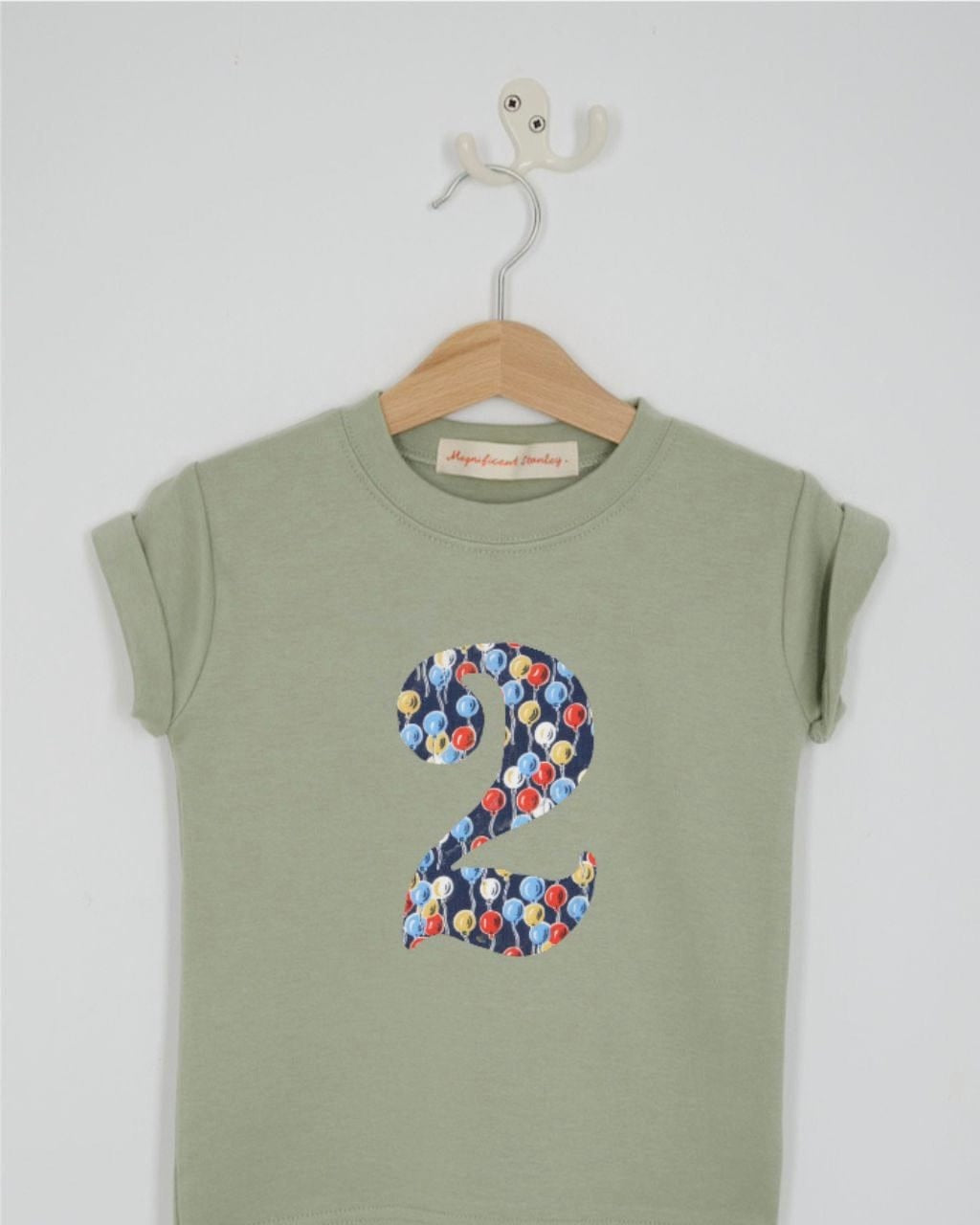 a number 2nd birthday kids sage green t-shirt with a number cut from ethan's party balloon liberty print on the front.