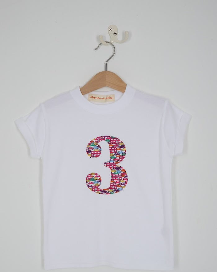 a kids white t-shirt with a number 3 cut from Hop on hop off red cars and london bus liberty print on the front