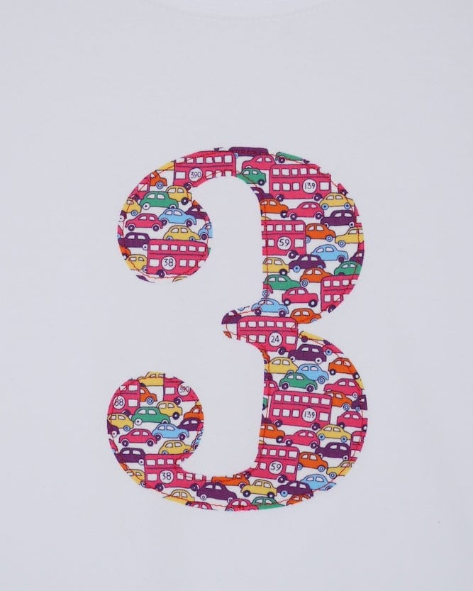 a kids white t-shirt with a number 3 cut from Hop on hop off red cars and london bus liberty print on the front