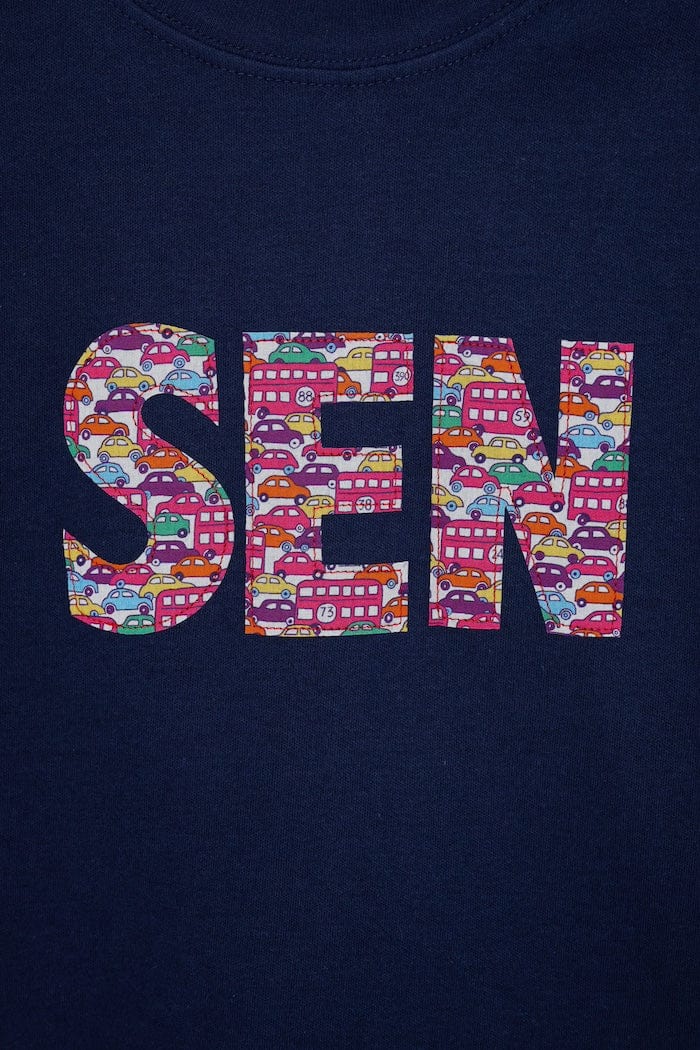 A navy cotton personalised t-shirt with his name on cut from liberty print featuring London buses and vintage cars.