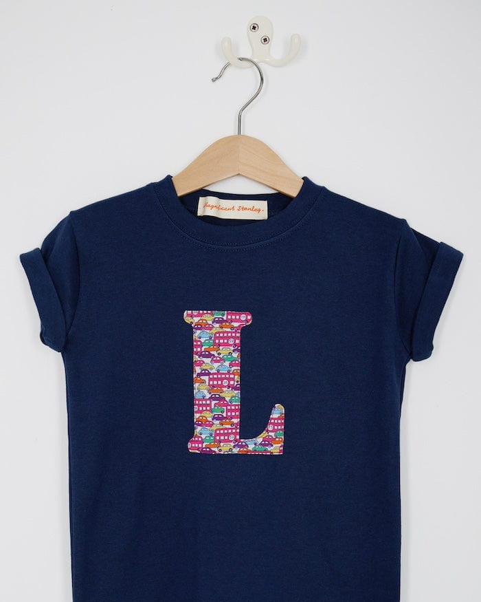 a navy cotton kids t-shirt with the letter 'L' personalised in a red Hop on hop off Liberty print.