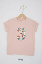 a pink 3rd birthday t-shirt with a number 3 cut from libby liberty floral print on the front