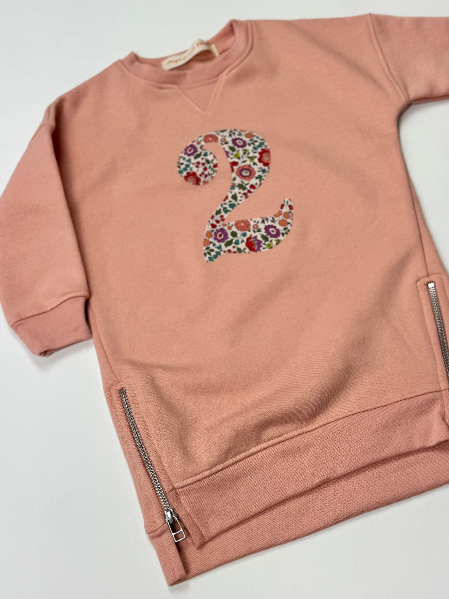 Pink sweatshirt dress with a liberty floral number '2' on a white background