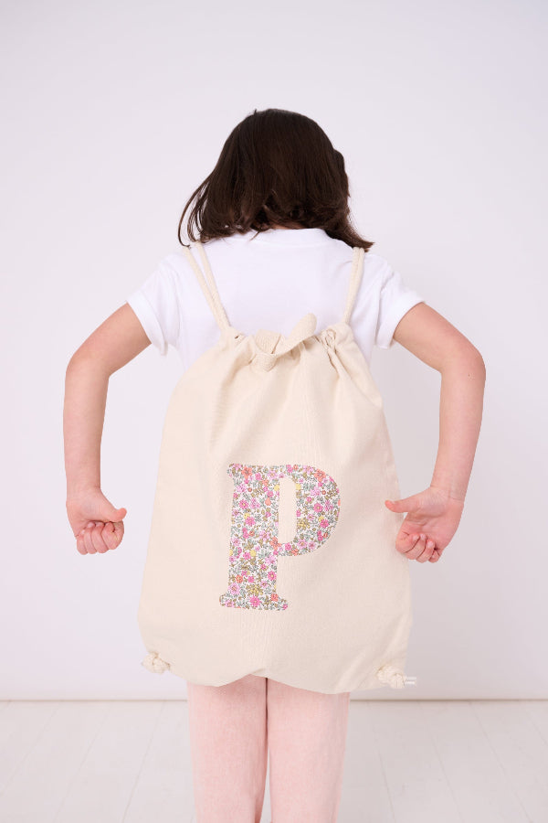 A child wearing a Personalised floral Liberty Print drawstring backpack rucksack