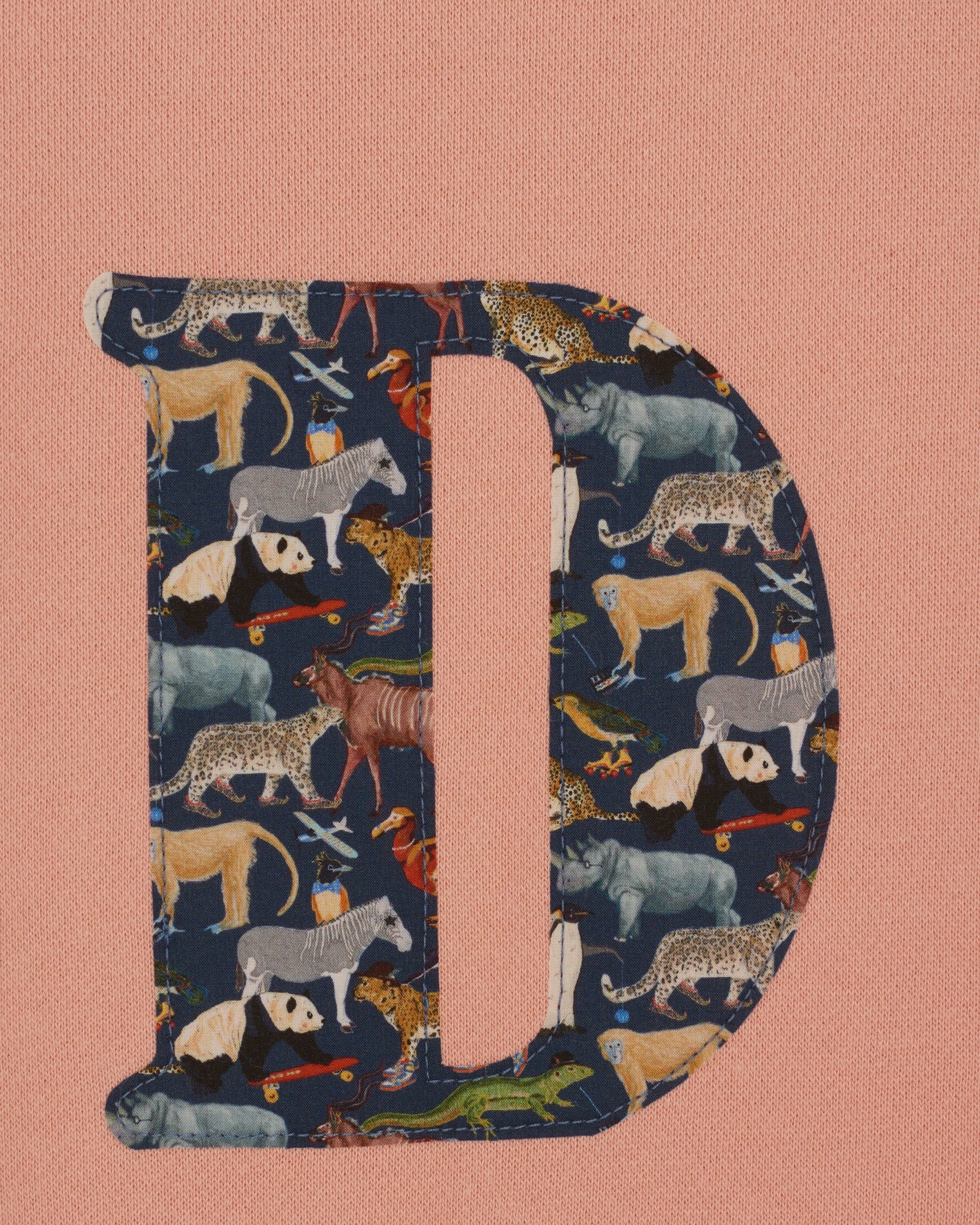 a personalised dusty pink sweatshirt with an initial on in floral Quey 2 Liberty print on the front.