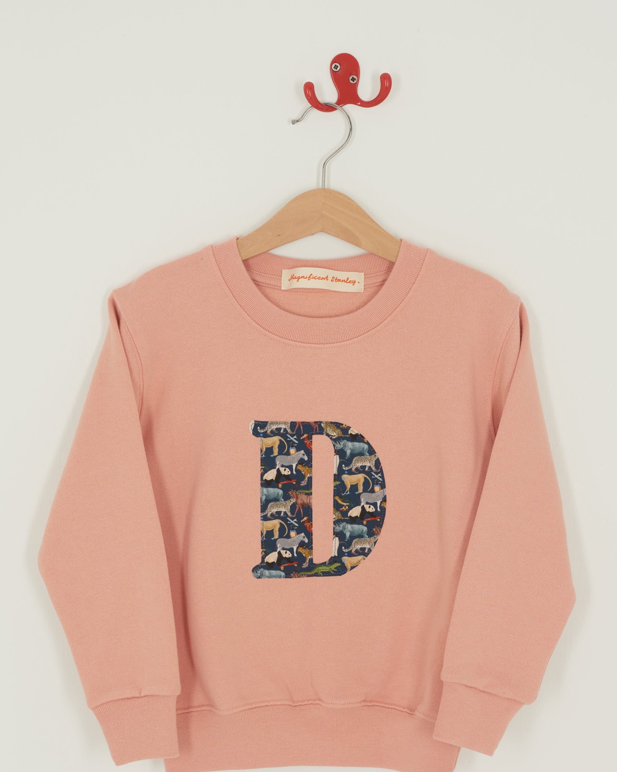 a personalised dusty pink sweatshirt with an initial on in Quey 2 Liberty print on the front.