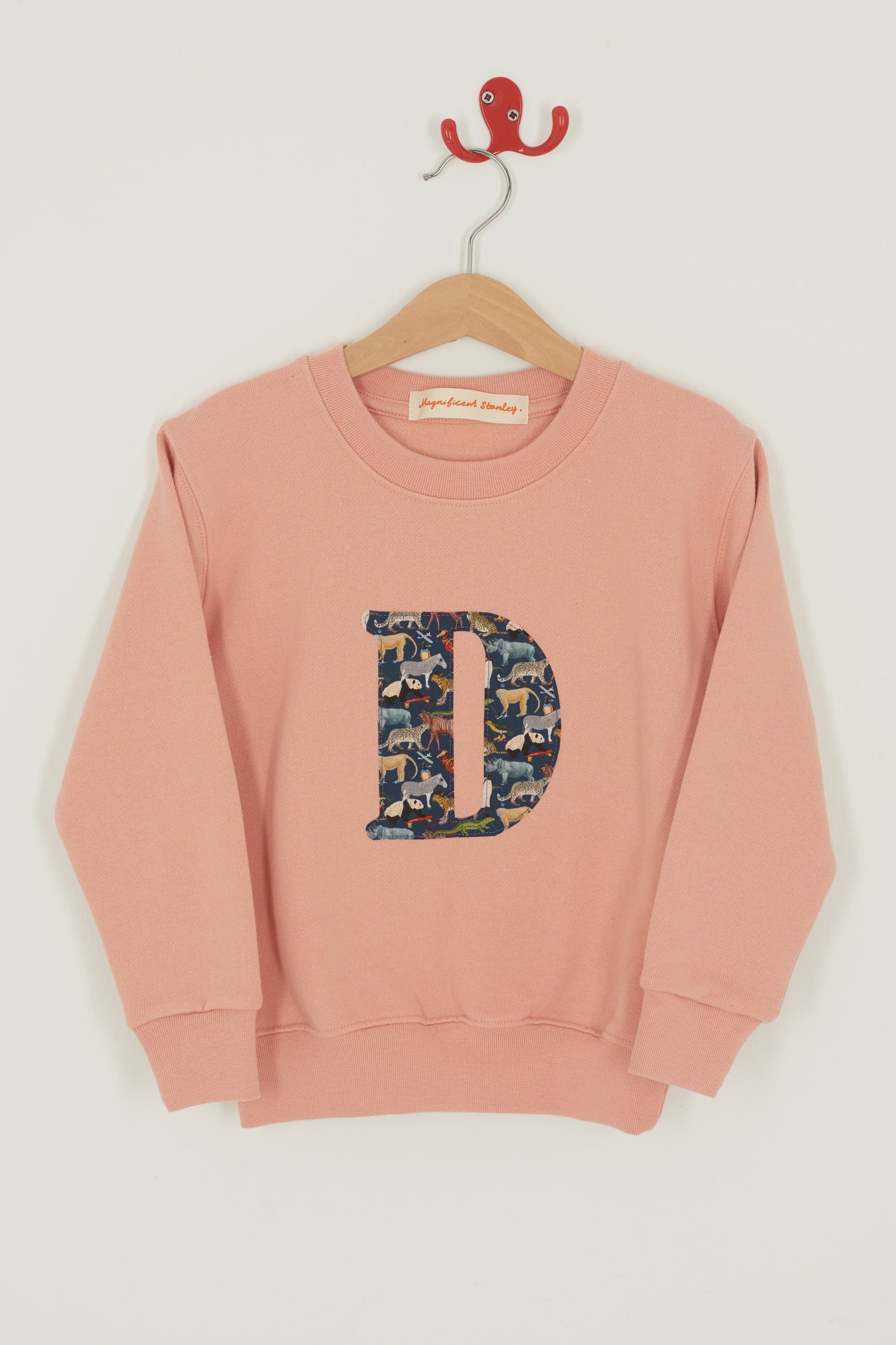 a personalised dusty pink sweatshirt with an initial on in Quey 2 Liberty print on the front.