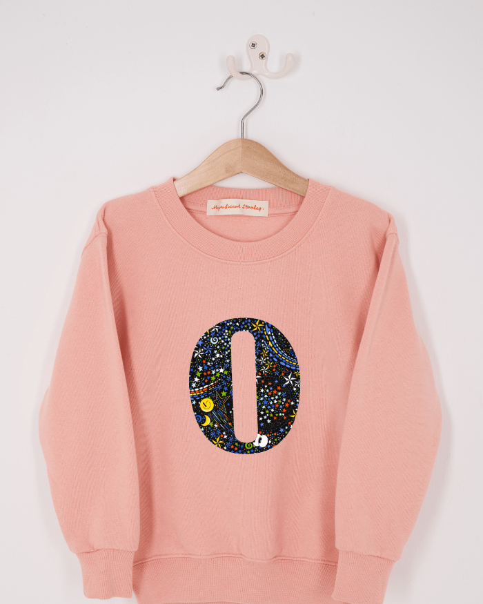 a personalised dusty pink sweatshirt with an initial on in Adelajda in Space Liberty print on the front.
