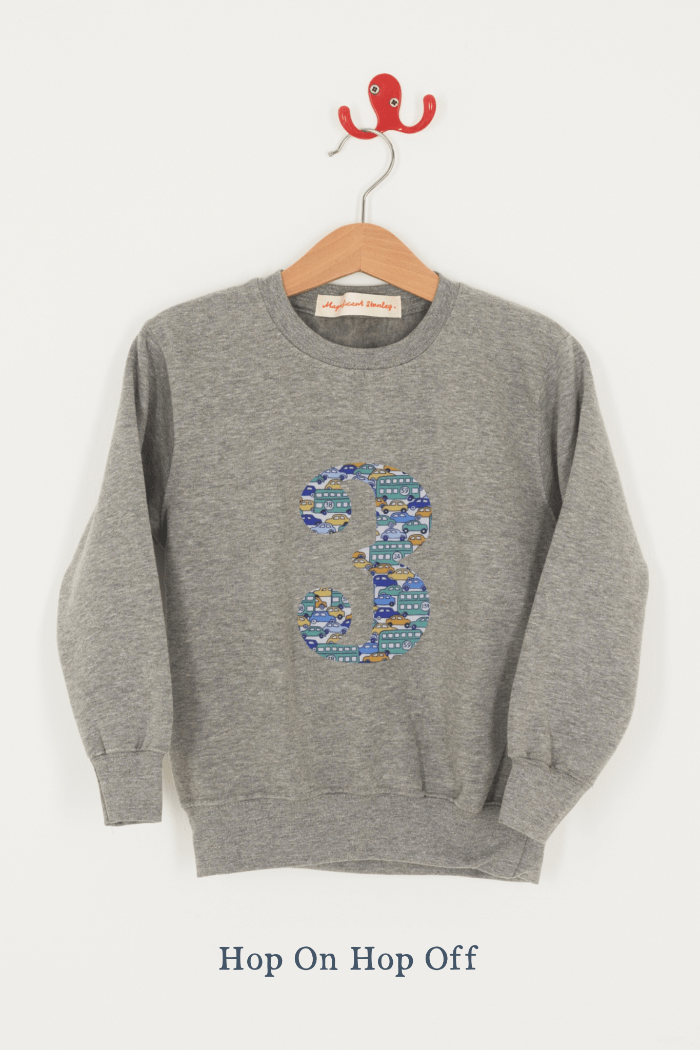 A birthday grey sweatshirt with a number 3 on in cars Liberty fabric.