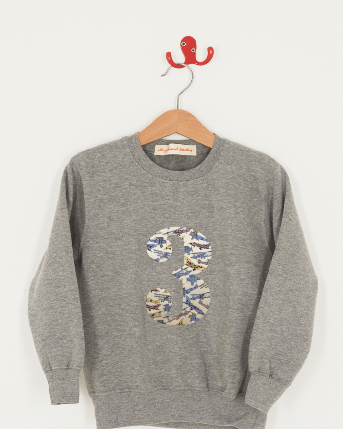 A birthday grey kids sweatshirt with a number 3 on in jet planes Liberty fabric.