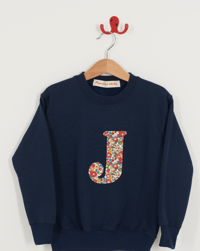 A personalised navy sweatshirt with an initial on in Betsy Ann Liberty fabric.