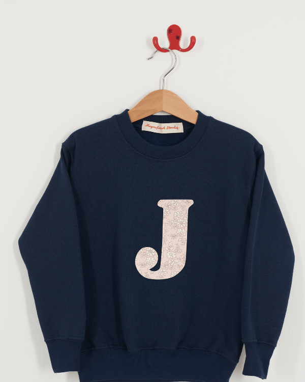 A Magnificent Stanley kids personalised Navy Sweatshirt with an initial on the front in capel pink liberty print.