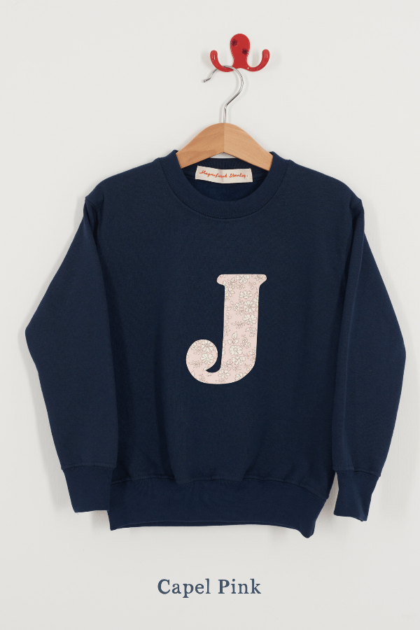 A Magnificent Stanley kids personalised Navy Sweatshirt with an initial on the front in capel pink liberty print.