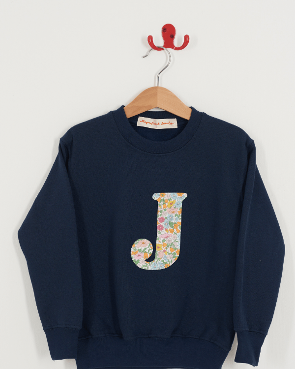 A Magnificent Stanley kids personalised Navy Sweatshirt with an initial on the front in poppy forest liberty print.