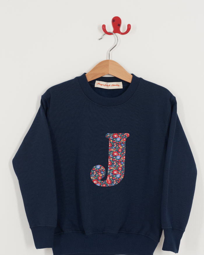A Magnificent Stanley kids personalised Navy Sweatshirt with an initial on the front in Betsy Star liberty print.