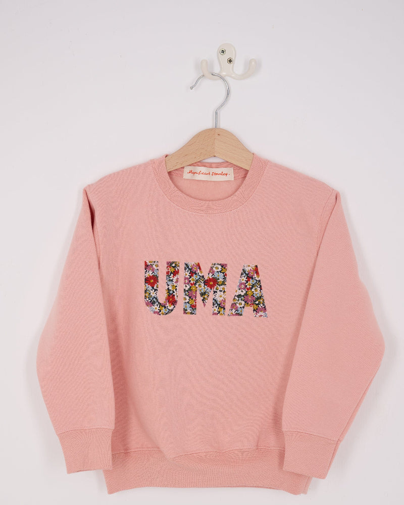 a Magnificent Stanley Dusty Pink Sweatshirt  with the name UMA sewn on in Libby floral Liberty Print