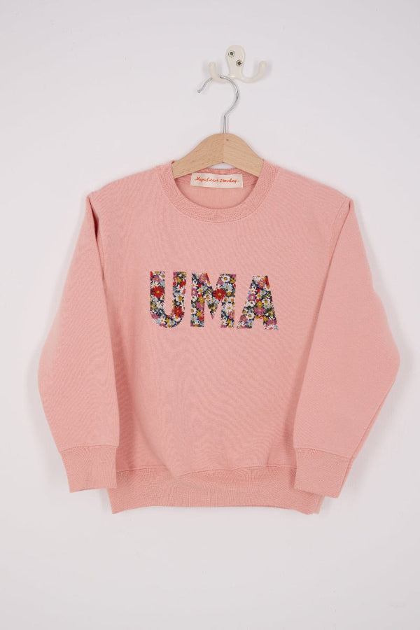 a Magnificent Stanley Dusty Pink Sweatshirt with the name UMA sewn on in Libby floral Liberty Print