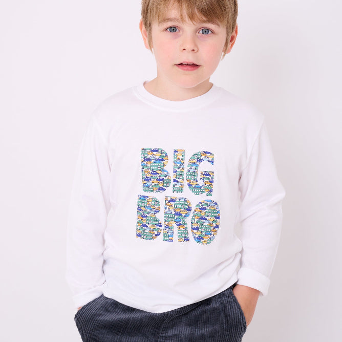 5 year old boy who is a Big Brother wearing a white cotton  t-shirt with BIG BRO sewn onto it in vintage liberty cars print.