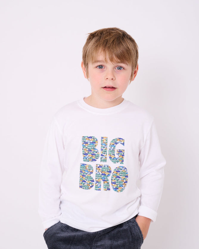5 year old boy who is a Big Brother wearing a white cotton t-shirt with BIG BRO sewn onto it in vintage liberty cars print.